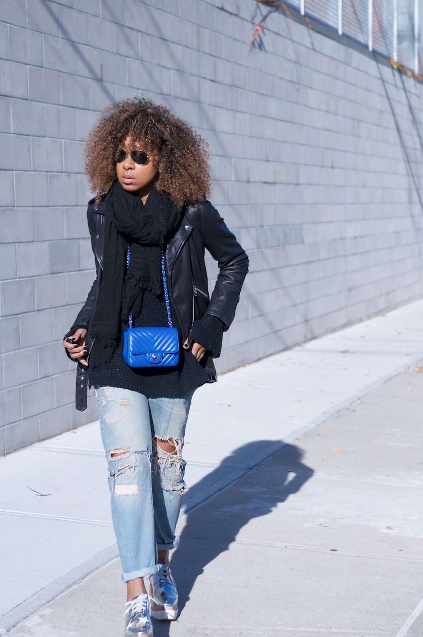Karen Blanchard wearing a Chanel square mini bag with a Lucky Brand leather jacket and ripped denim jeans