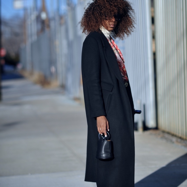 Karen Blanchard wearing a black H&M coat with zara red suede bow ankle boots and cropped levi jeans