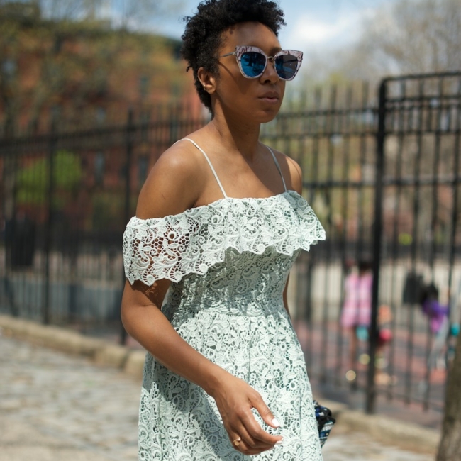 Karen blanchard with natural hair wearing statement sunglasses and an H&M lace dress