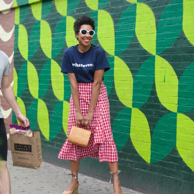 Karen Blanchard is wearing white sunglasses with a gingham ruffle skirt and Castaner espadrilles